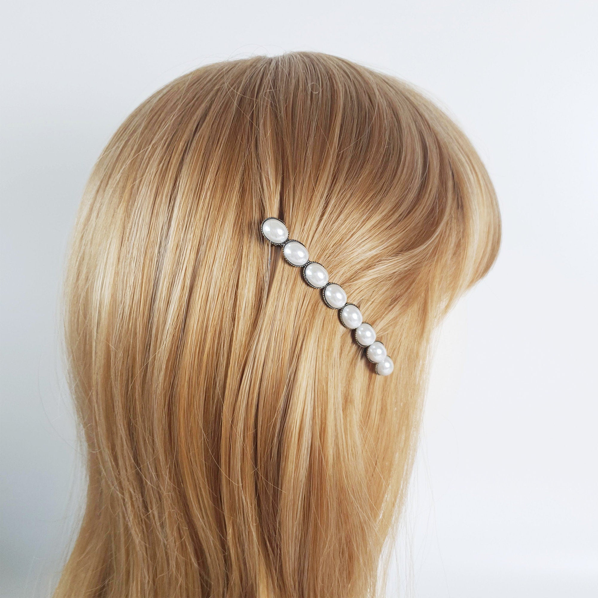 Vintage style antique brass French barrette featuring a row of four glossy oval acetate stones. 3.1 inch retro hair clip for half-up and side hair styling.