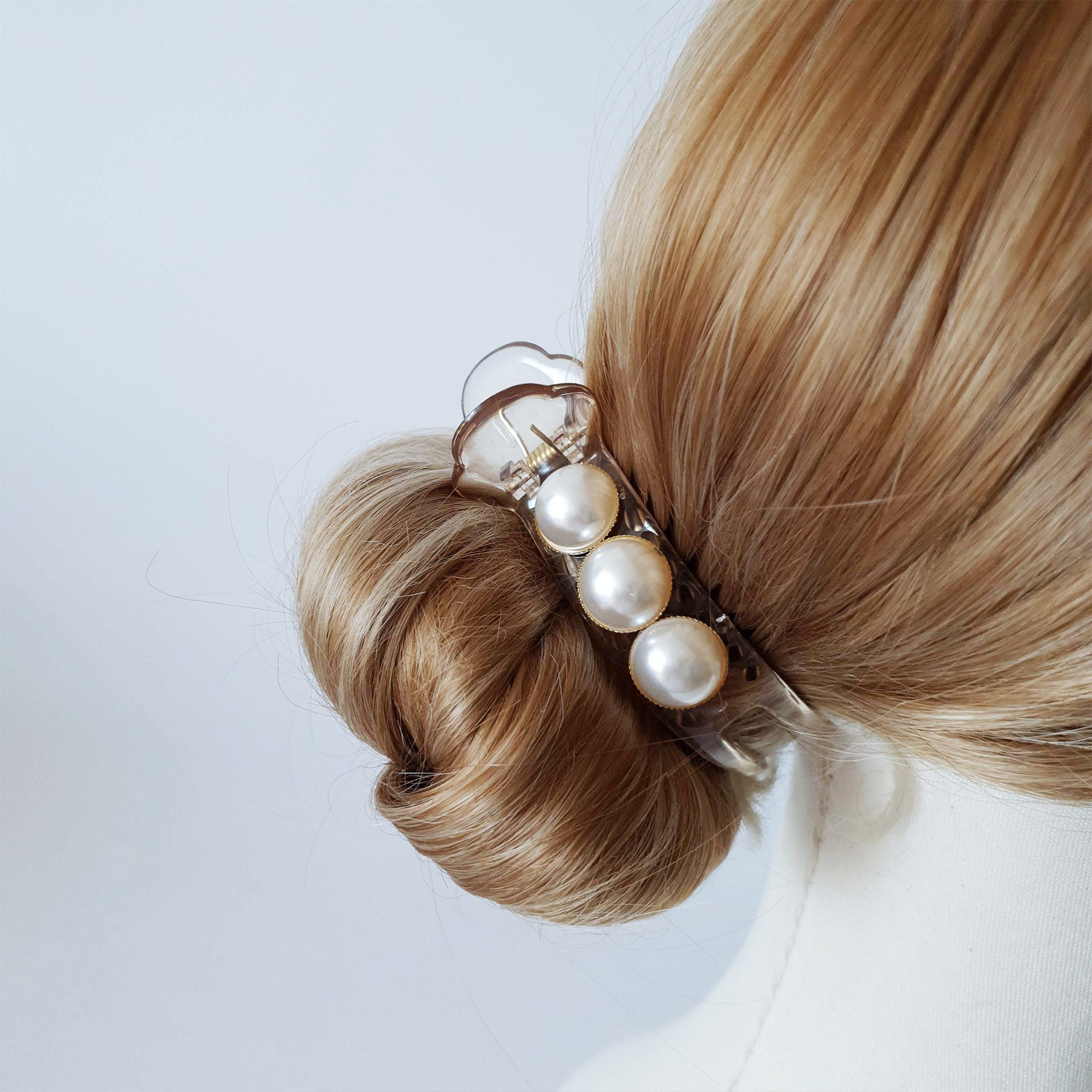 White pearl hair claw clip made of clear and black acetate, available in rectangular and round shapes for bridal updos, buns, and half up hairstyles.