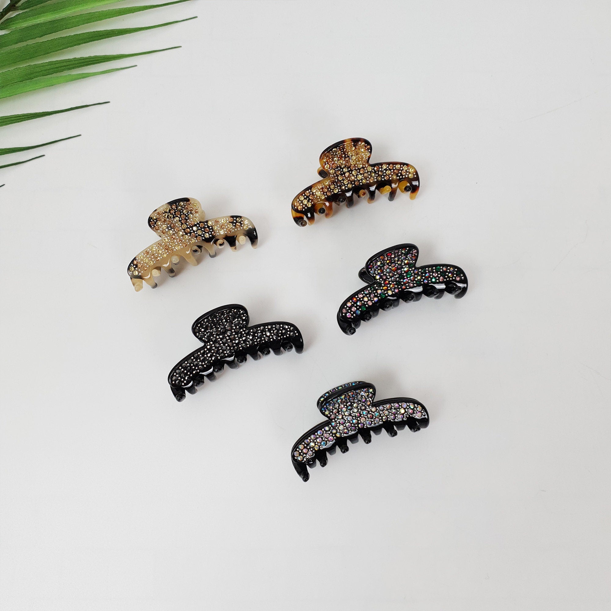 Small rhinestone hair claw clip made of cellulose acetate featuring crystal embellishments in leopard and black colors for half up hairstyles and fine hair.