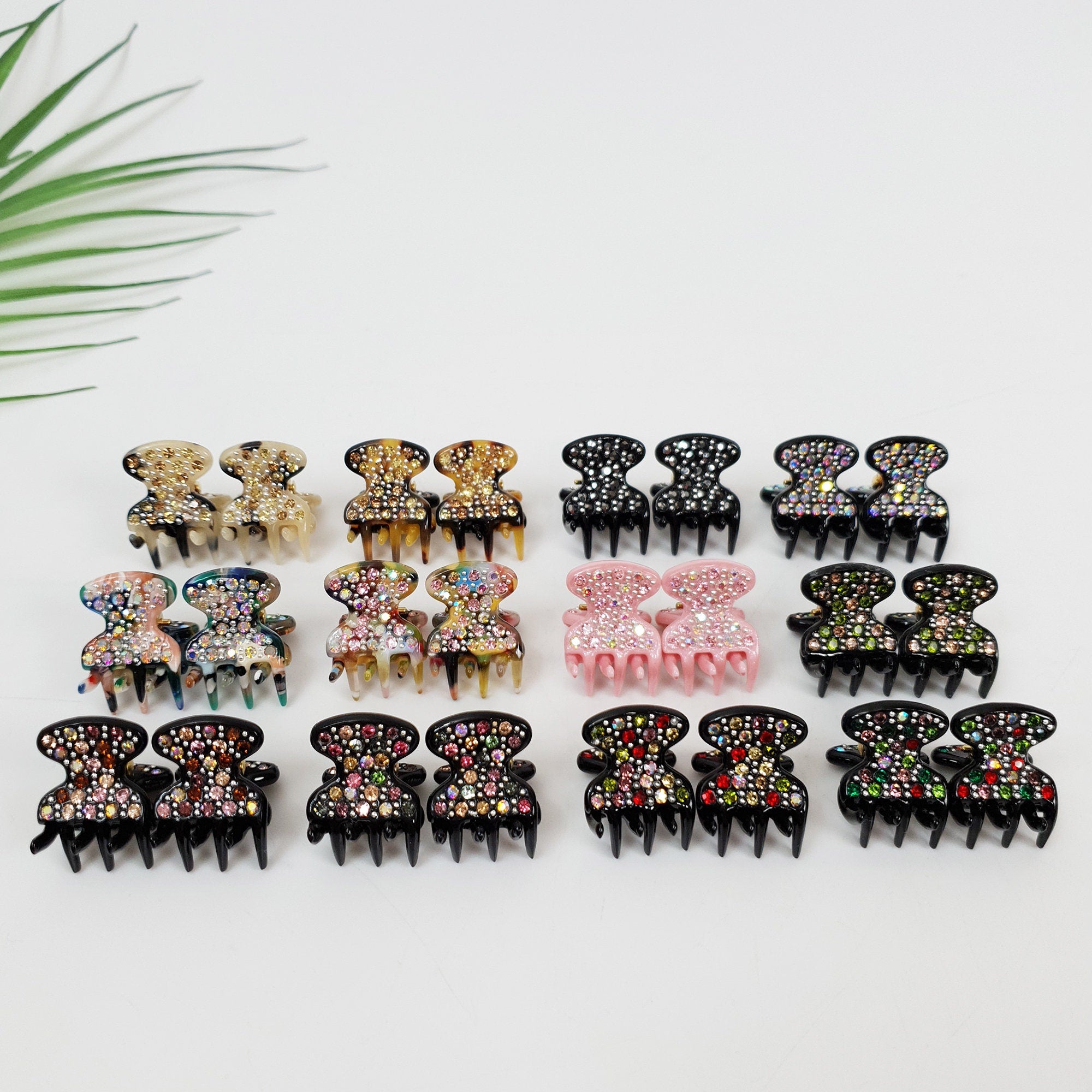 Set of 2 mini cellulose acetate flower hair claws with rhinestone embellishments for side bangs and half-up styling.