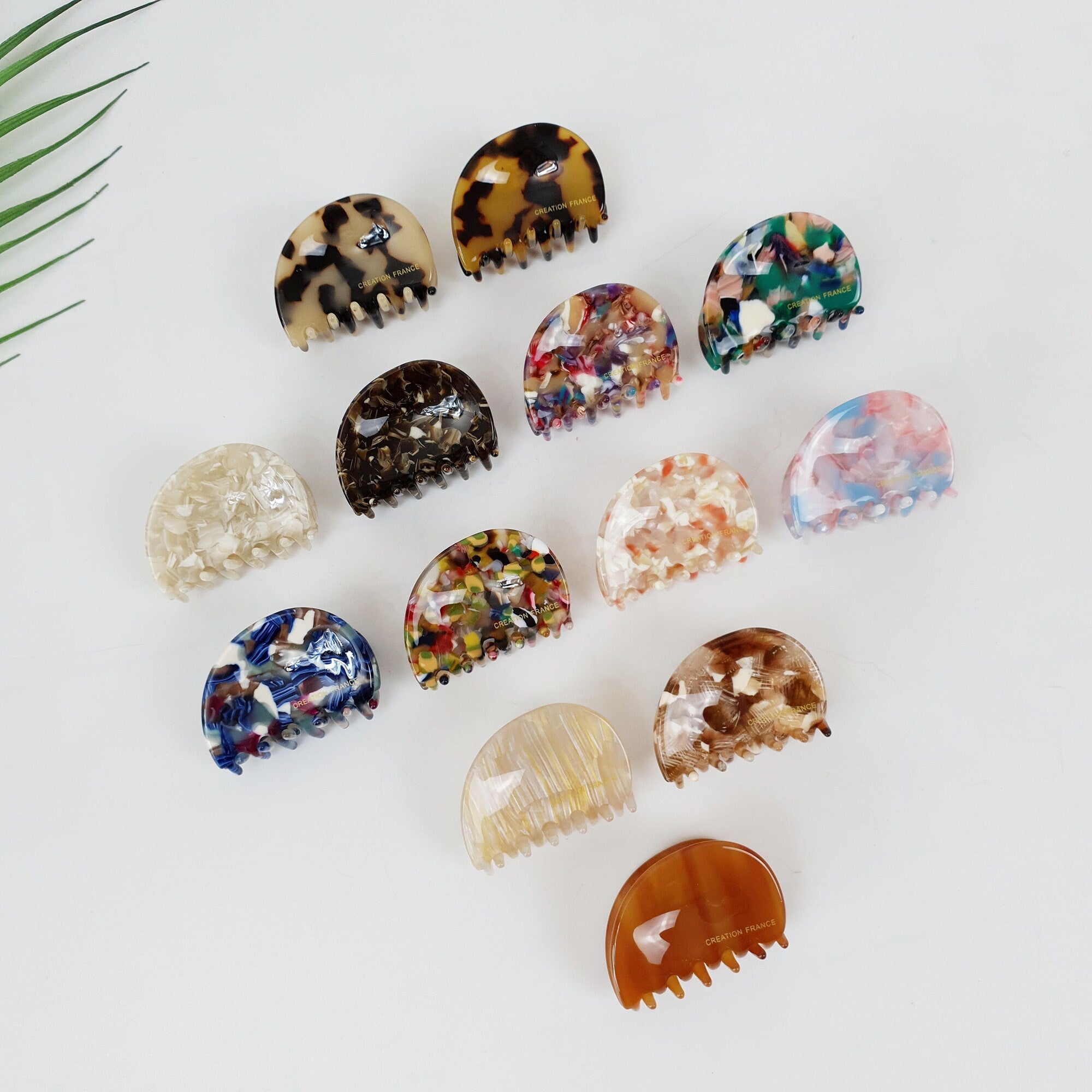 Small pebble shaped cellulose acetate hair claw clip in tortoise shell and marble patterns. 1.8 inch minimalist semi-circle jaw clip for half-up hairstyles.
