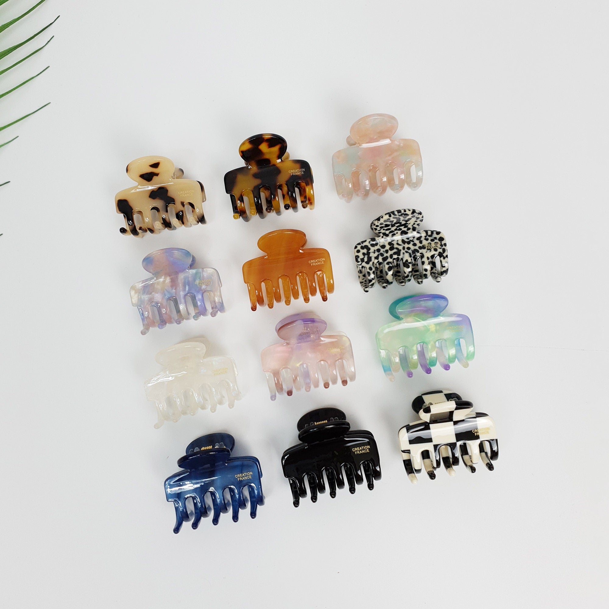Small cellulose acetate hook hair claw clip in checkerboard and tortoise patterns. Mini jaw clip for half up hairstyles.