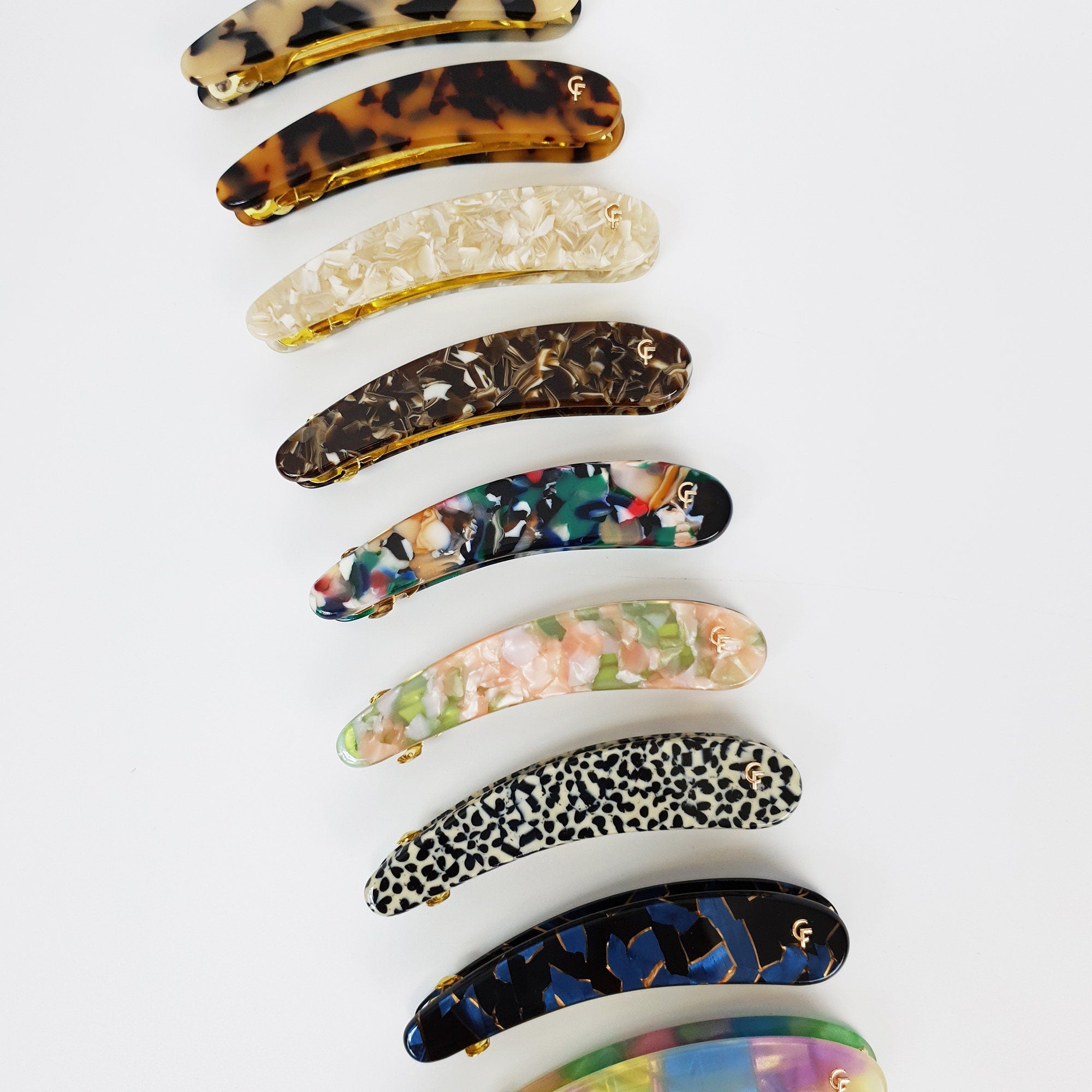 Cellulose acetate long slim curved automatic hair clip in tortoise shell and marble patterns. 3.5 inch ponytail holder for half up hairstyles.