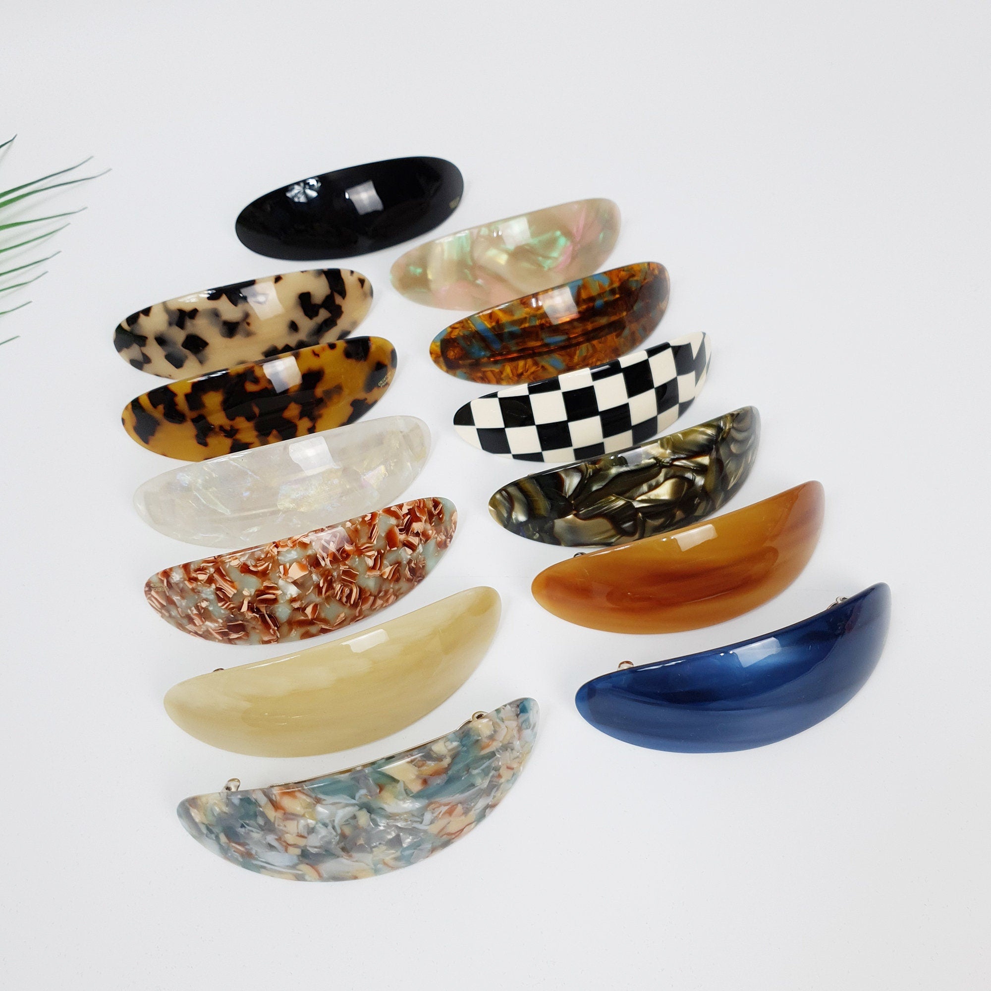 Cellulose acetate oval hair barrette in blue and tortoise shell patterns. 3.7 inch curved automatic hair clip for ponytails and half-up hairstyles.