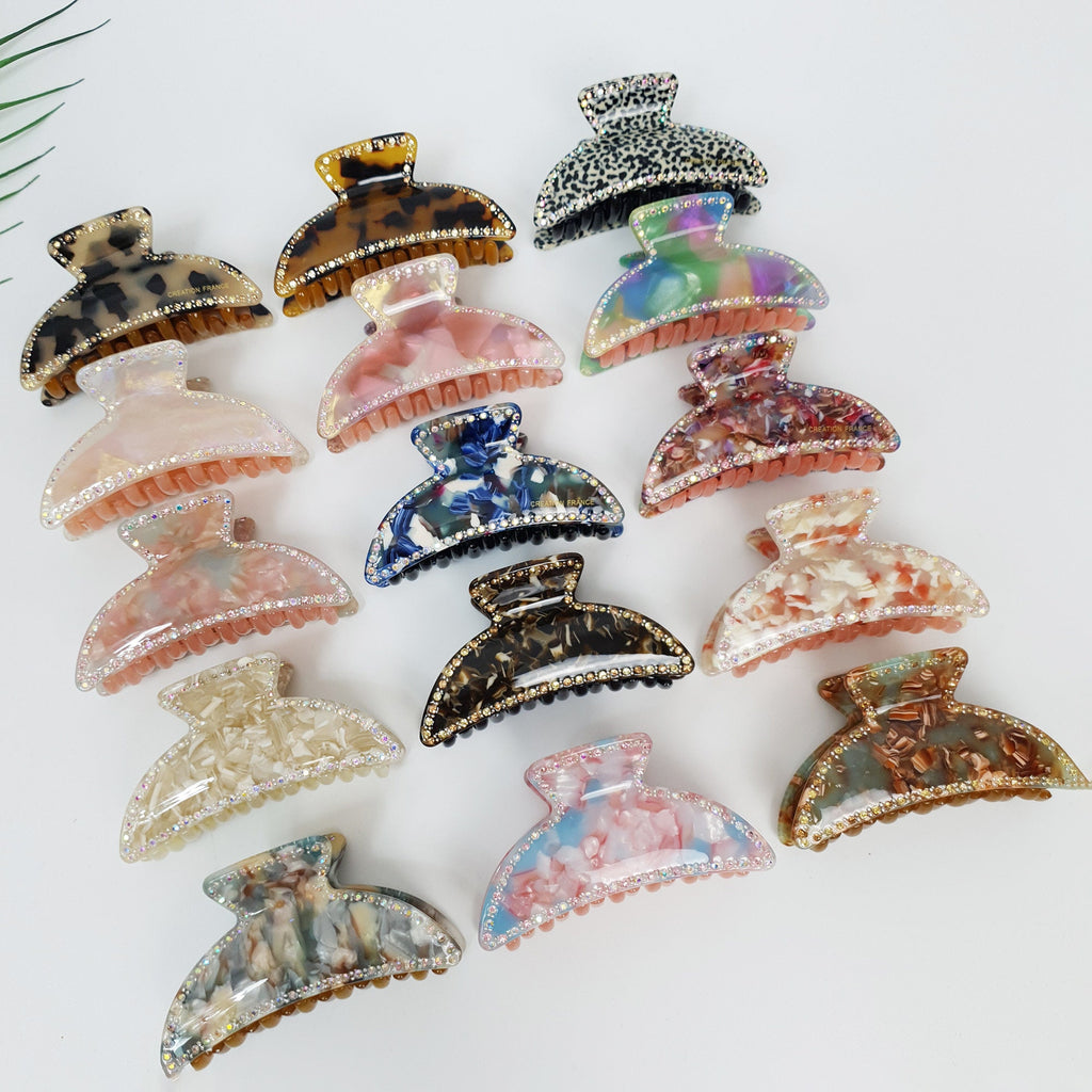 Medium cellulose acetate hair claw with rhinestone crystal details. Marble and tortoise pattern semi circle jaw clip for half up hairstyles.