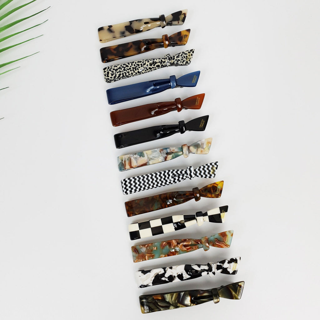 Cellulose acetate hair clip in tortoise shell and checkered patterns. 3.5 inch duckbill side clip with knot detail for women.