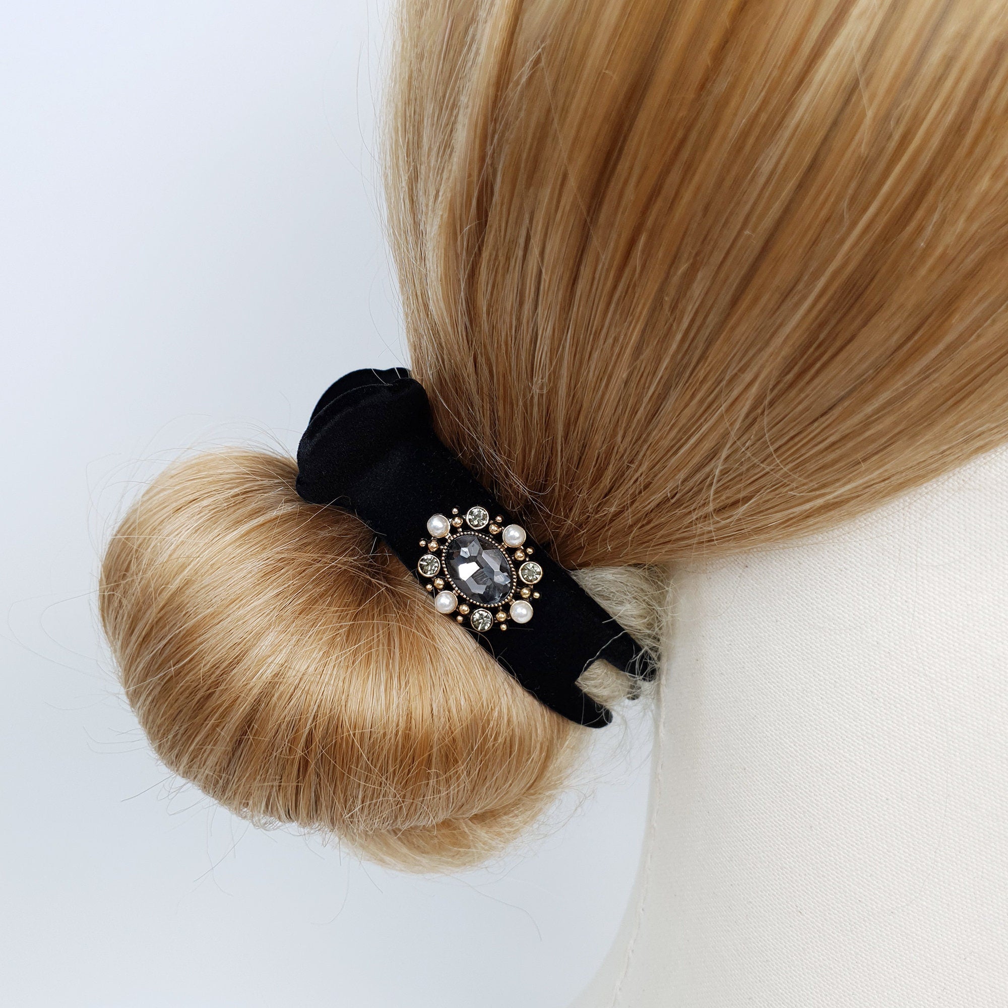 Black velvet circular hair claw clip with pearl and rhinestone center embellishment. Round bun holder clamp for elegant updo hairstyles.