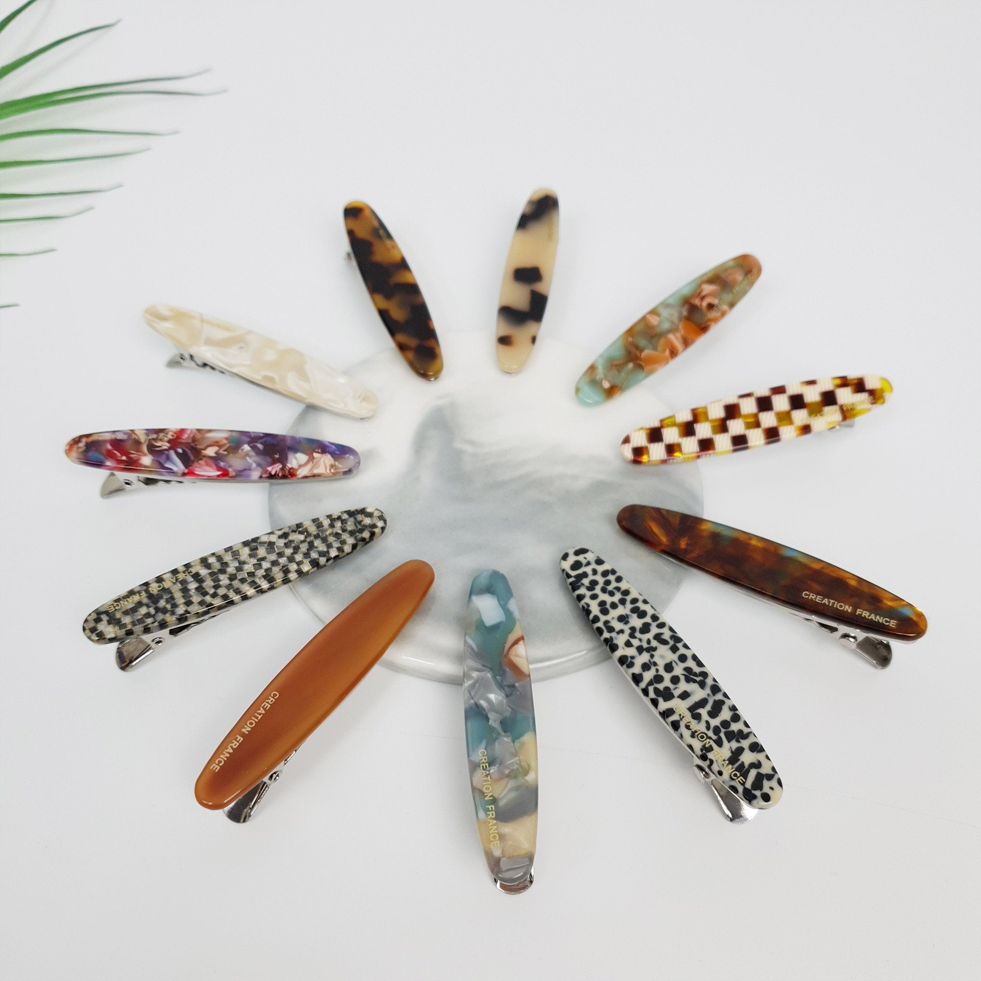 Small oval cellulose acetate hair clip in tortoise shell and marble patterns. 2.6 inch alligator clip for bangs and side hair styling.