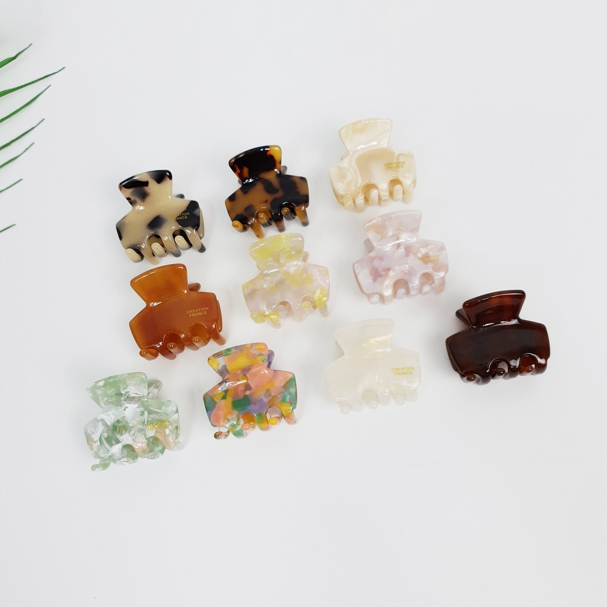 Small cellulose acetate square hair claw clip in tortoise shell and marble patterns. Mini geometric jaw clip for side hair or half-up styling.