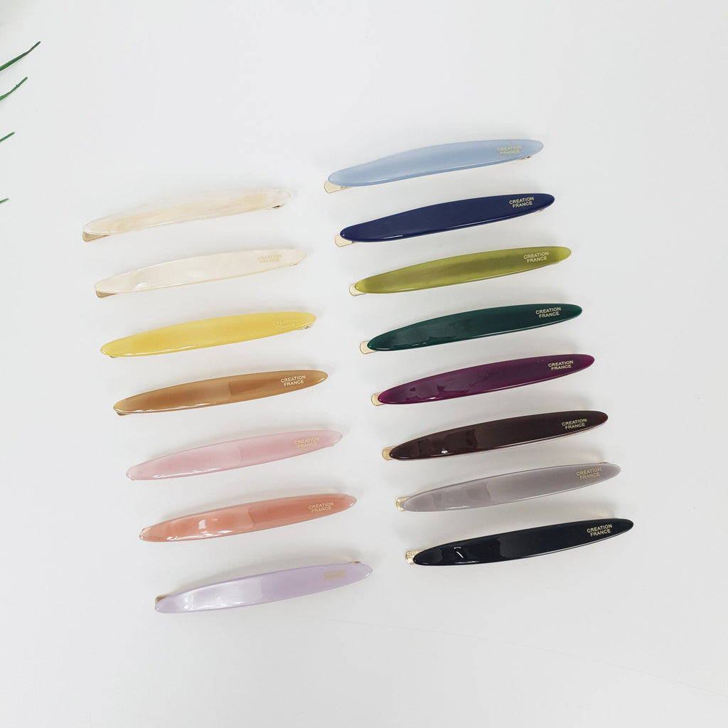 Pastel acetate oval hair slide with gold snap base, minimalist glossy barrette for side bangs styling, cute hair accessory for women. A set of 14 hair clips in various colors, including light blue, white, yellow, brown, pink, purple, green, dark green, dark purple, maroon, gray, and black. Each clip has a curved shape and features the text 'CREATION FRANCE' in gold lettering.