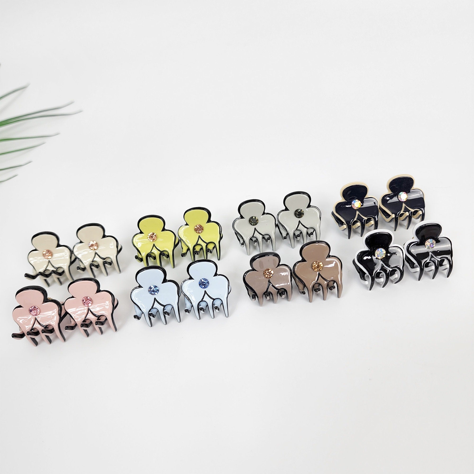 Set of 2 mini cellulose acetate flower hair claw clips. Pastel three petal design with rhinestone center. 0.8 inch tiny jaw clamps for bangs and girls.