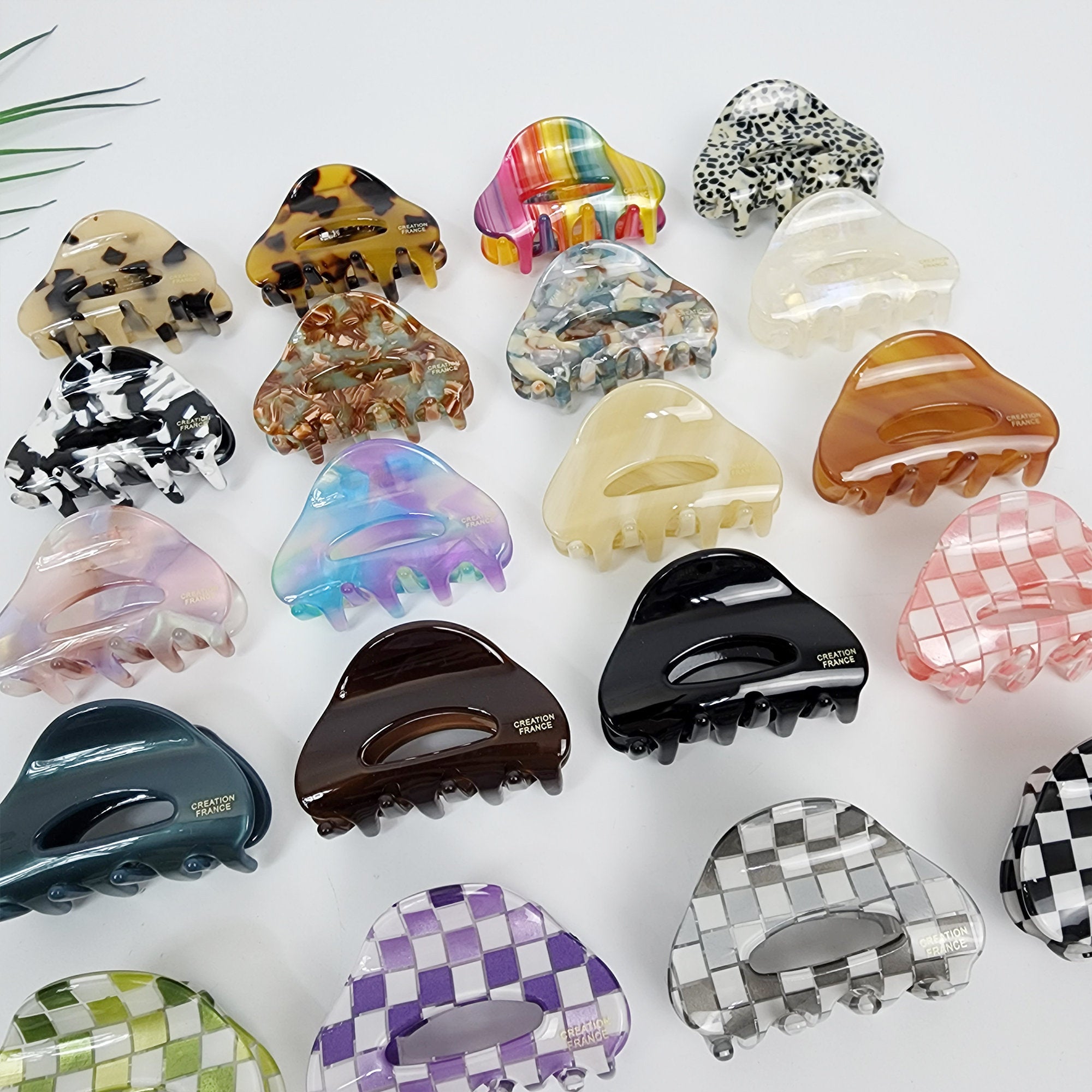 Small cellulose acetate hair claw clips in tortoise shell and checkerboard patterns. Triangle jaw clips for half up hairstyles.