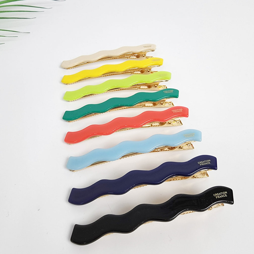 Cellulose acetate wavy hair clip in vivid colors, squiggle barrette for side bangs, scalloped alligator clip for women, retro minimal hair accessories.  A set of eight wavy hair clips in various colors including cream, yellow, green, teal, coral, light blue, navy blue, and black. Each clip has a gold metal clasp with the words 'CREATION FRANCE' printed on it.