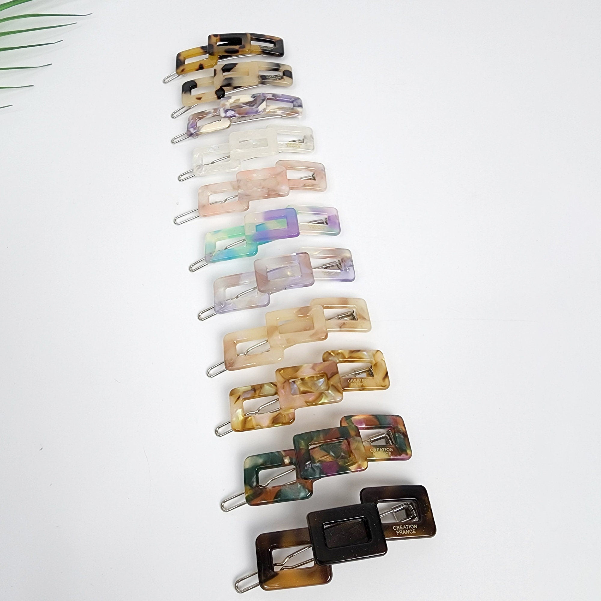 Cellulose acetate rectangular chain link hair clip in tortoise shell and aurora marble patterns. Geometric snap barrette for bangs and side hair styling.