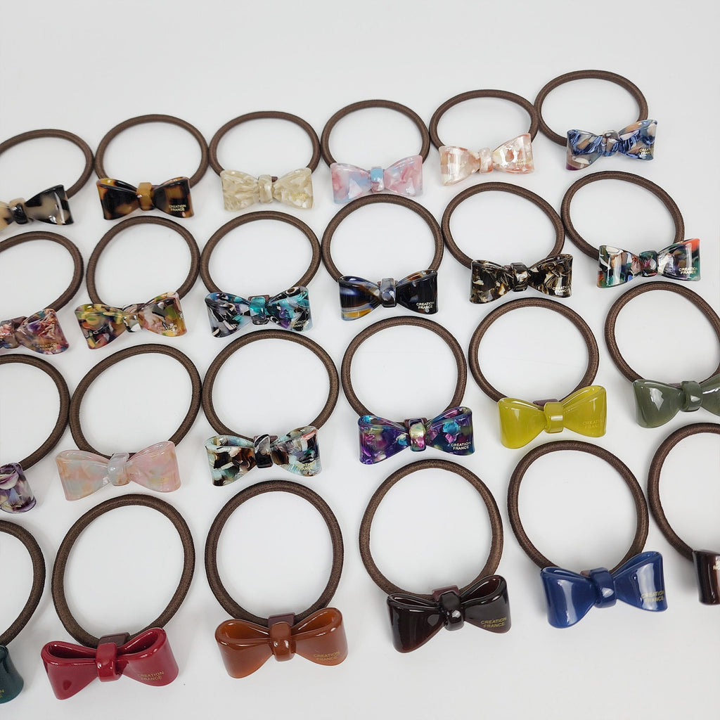 Glossy cellulose acetate mini ribbon hair tie in tortoise shell and marble colors. Small 1.6 inch bow ponytail holder. Preppy Korean fashion accessory for women birthday gift.