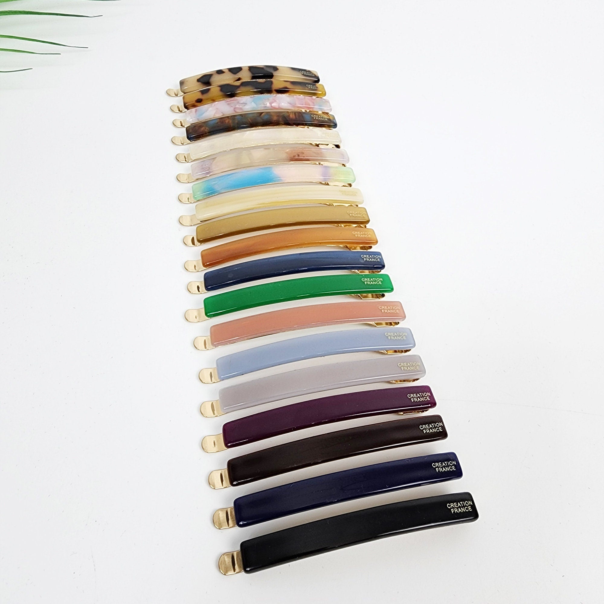 Cellulose acetate flat bobby pin in tortoise shell and marble patterns, minimal gold hair slide for holding bangs and side hair.