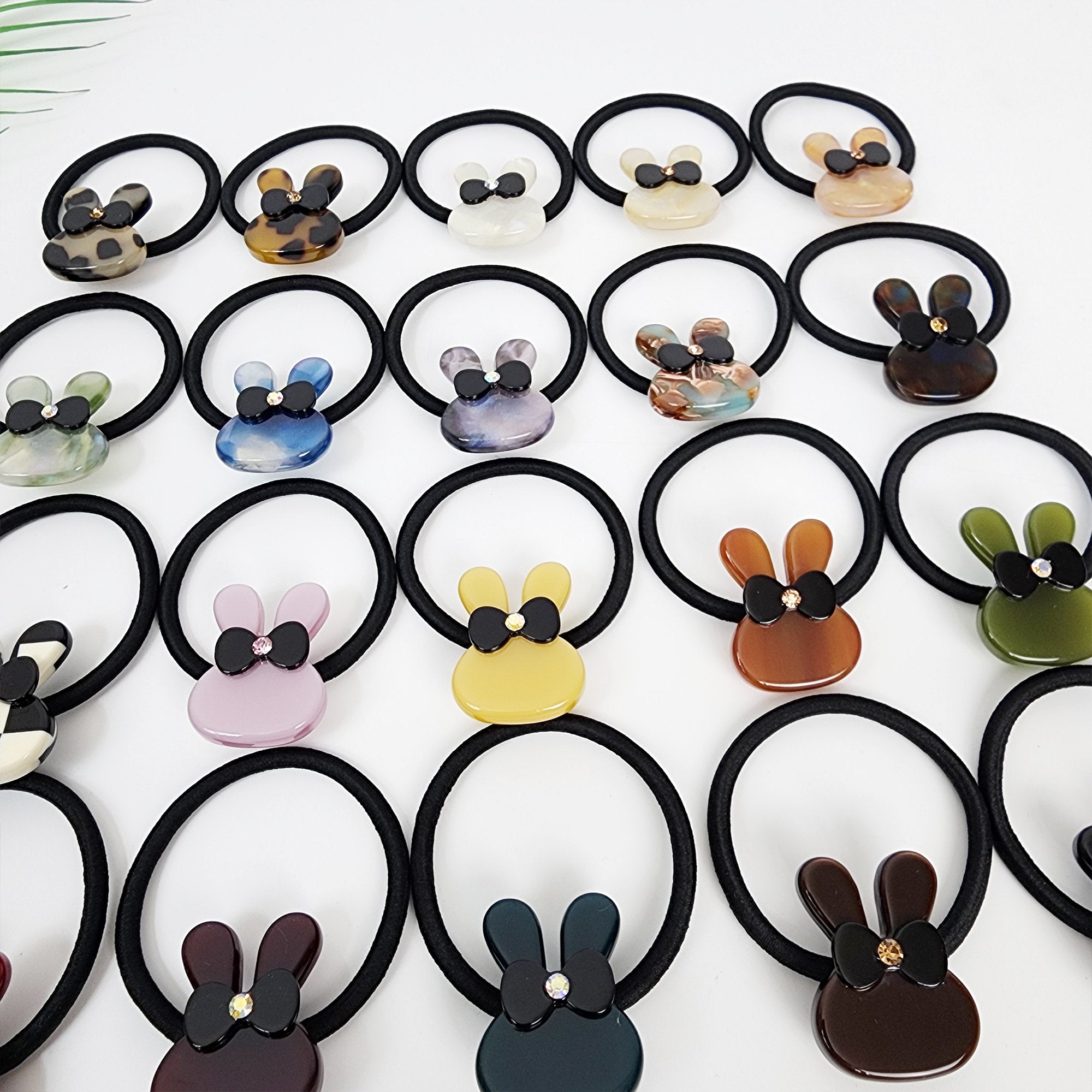 Cellulose acetate bunny hair tie with cubic zirconia bow, cute rabbit ponytail holder in 20 colors, playful animal accessory for birthday gifts.