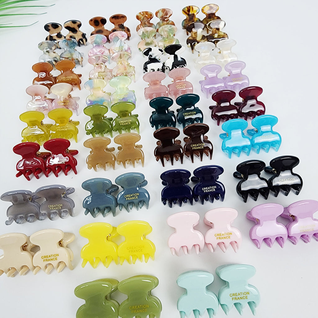 Cellulose acetate mini octopus hair clips in solid colors and tortoise shell, small claw clips for side hair styling and bangs, cute non-slip french accessories for women and girls. A collection of assorted plastic hair clips in various colors, including blue, green, red, purple, pink, and black. The clips have a claw design and feature the text 'CREATION FRANCE' on the front.