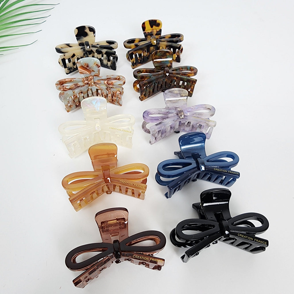Cellulose acetate ribbon bow hair claw in tortoise shell and aurora colors, 2.4 inch small jaw clip for half-up hairstyles, cute Korean hair accessory for women.