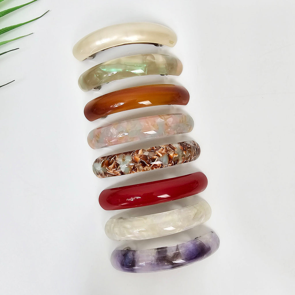 Cellulose acetate curved barrette hair clip. Long skinny automatic ponytail holder in tortoise and pearl colors for half updo.