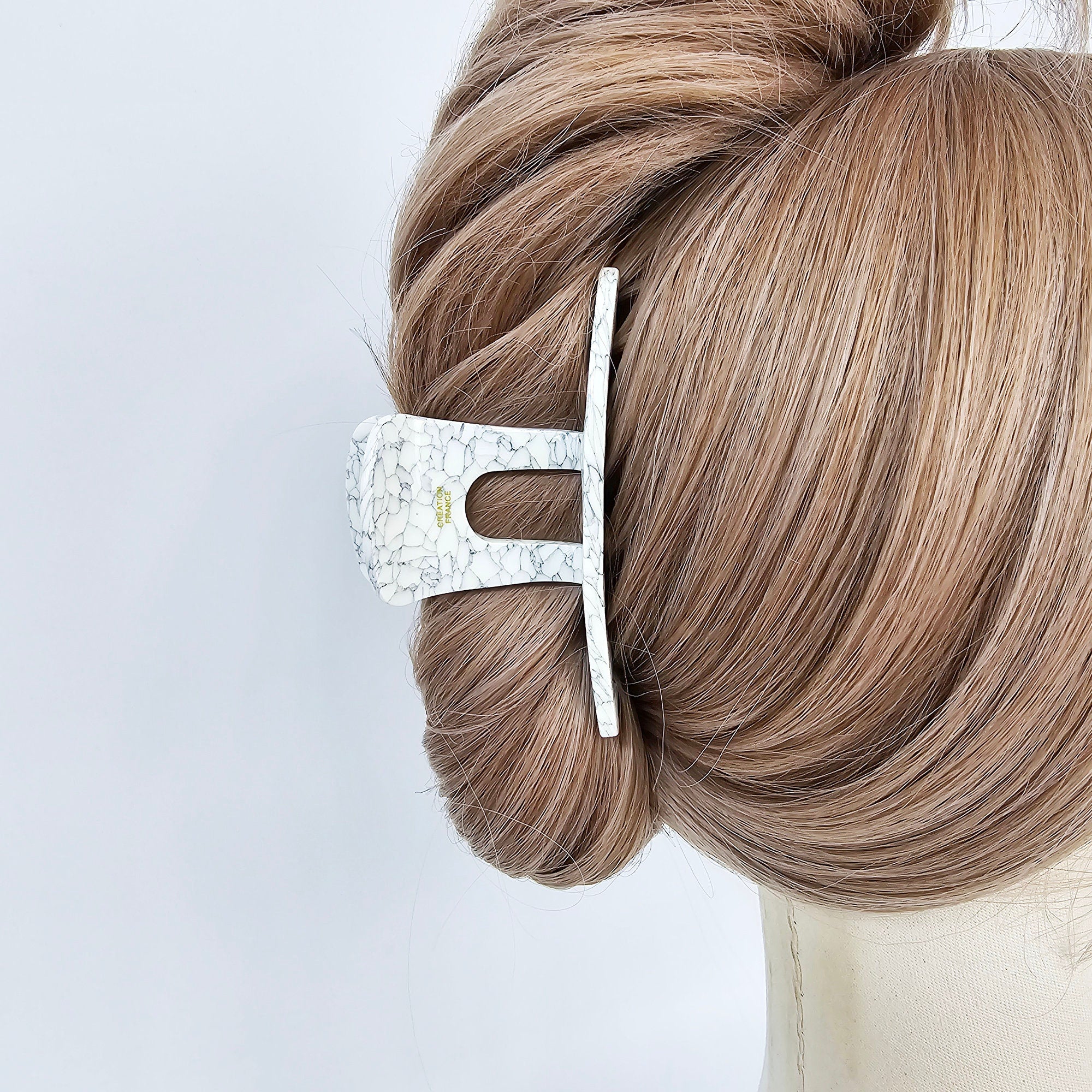 Large 3.9 inch acetate hair claw in white marble. Rectangular cutout design with strong grip for updos and thick hair.