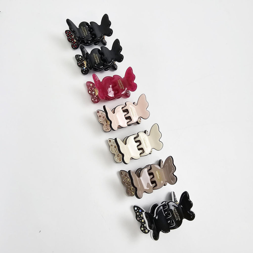 Set of 2 cellulose acetate mini butterfly hair claw clips with rhinestone accents. Cute small jaw clips for bangs and side hair styling.