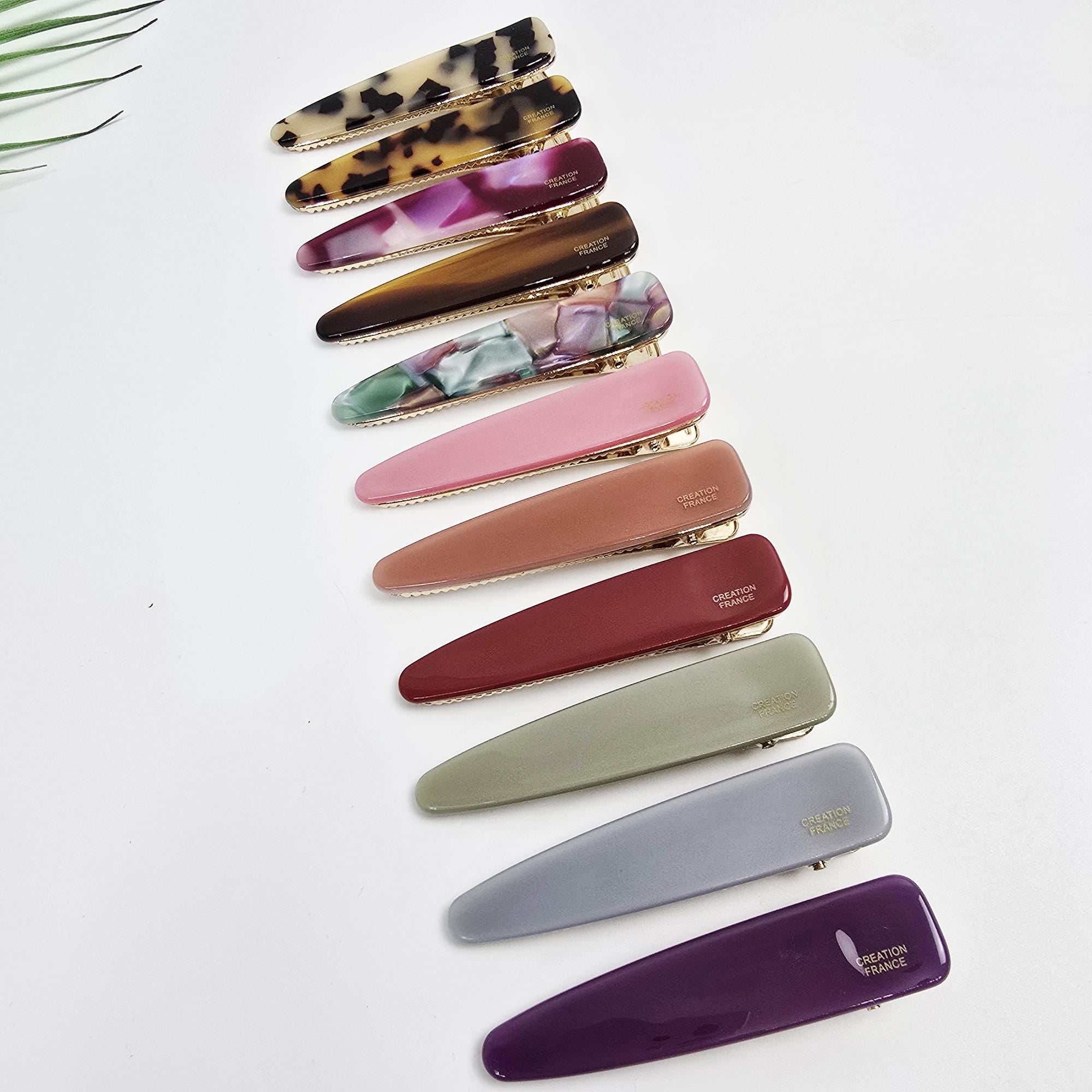 Long slim triangle hair clip made of cellulose acetate with a gold alligator clasp. 3-inch geometric barrette for side bangs.