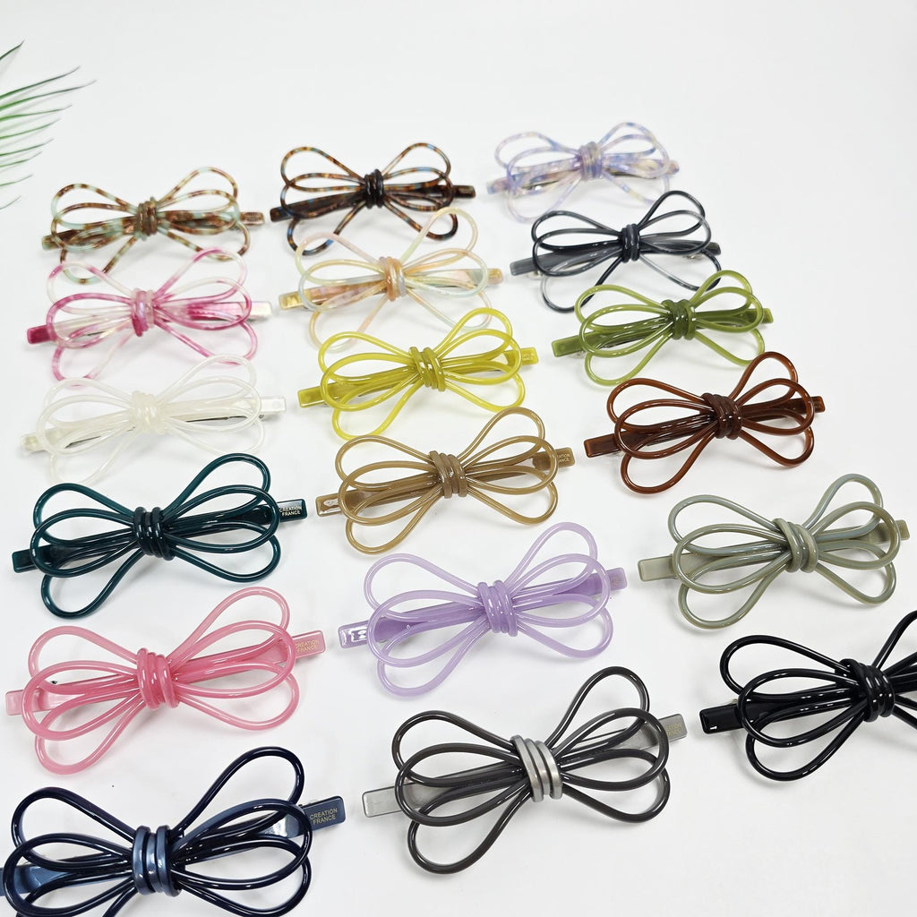 Cellulose acetate triple ribbon hair barrette in tortoise shell and pastel colors. Long automatic French clip for ponytails and half-up styles.