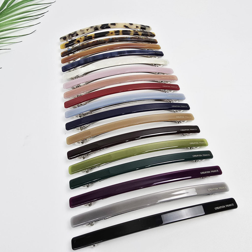Cellulose acetate long slim hair barrette in tortoise shell and marble patterns. 4.3 inch automatic french clip suitable for ponytails or half-up styles. Minimalist flat hair accessory.