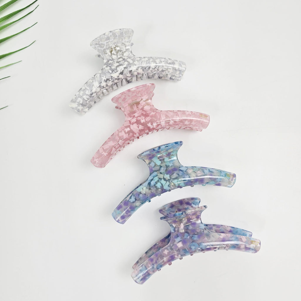 Cellulose acetate hair claw clip in tropical curved rectangular shape. 4.7 inch large jaw clip available in pastel colors. Perfect for securing french twists and updos.