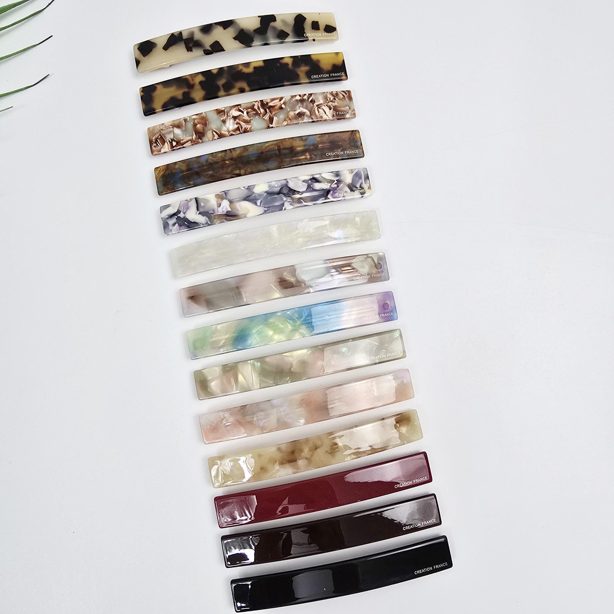 Cellulose acetate long slim hair barrette in tortoise shell and marble patterns. 4.3 inch automatic french clip suitable for ponytails or half-up styles. Minimalist flat hair accessory.