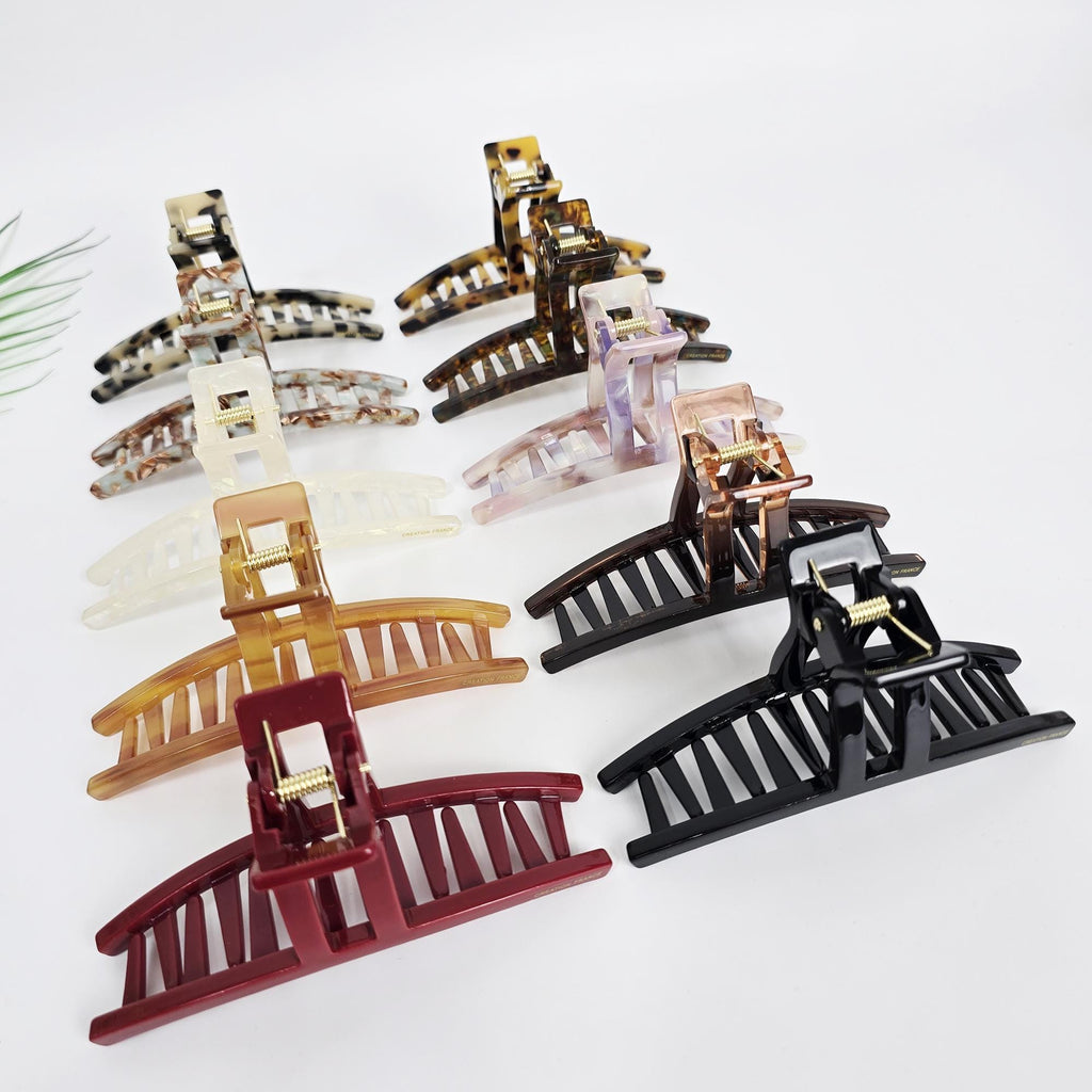 Large cellulose acetate hair claw clip with a curved rectangular design. 4.8 inch tortoise shell and solid color jaw clamp for thick hair updos.