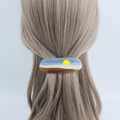 Cellulose acetate hair barrette with sunset landscape design. 3.5 inch french clip with blue sky and brown hills for women half up style. A brown and blue hair clip with a yellow sun design