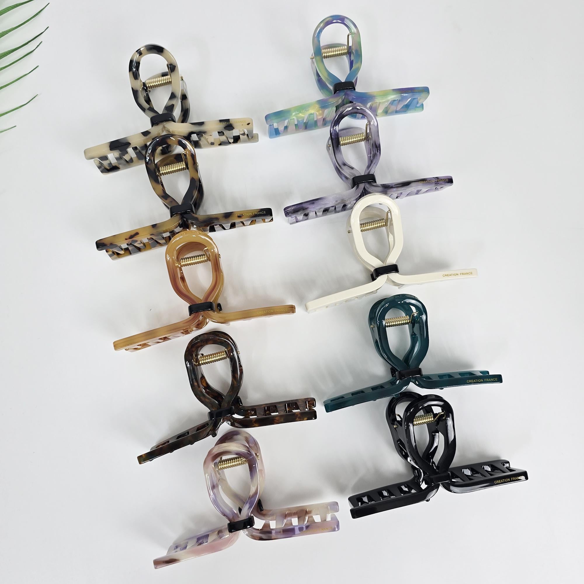 Cellulose acetate hair claw clip with twisted loop design. Large 4.3 inch jaw clip for thick hair updos. Available in tortoise shell and minimalist colors.