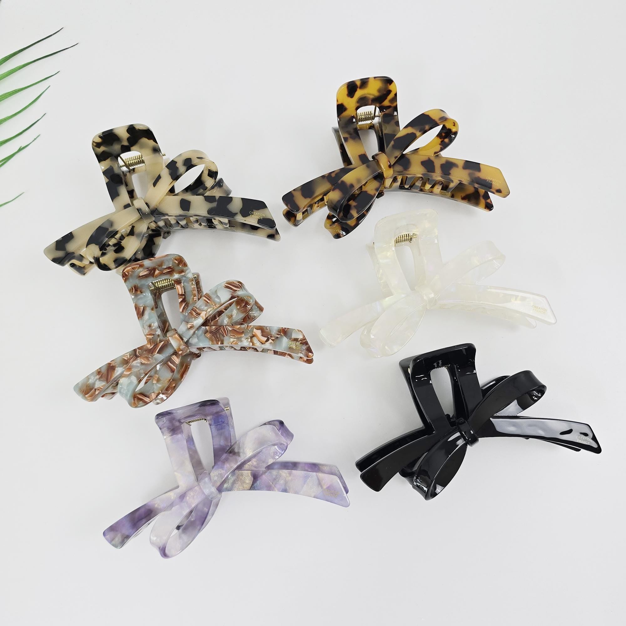 Acetate ribbon bow claw clip in tortoise shell and marble patterns for women's updo hairstyles, Korean fashion style.